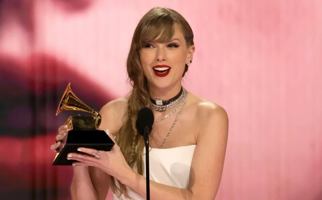 Taylor Swift accepting her 4th Album of the Year trophy Image Source Grammy